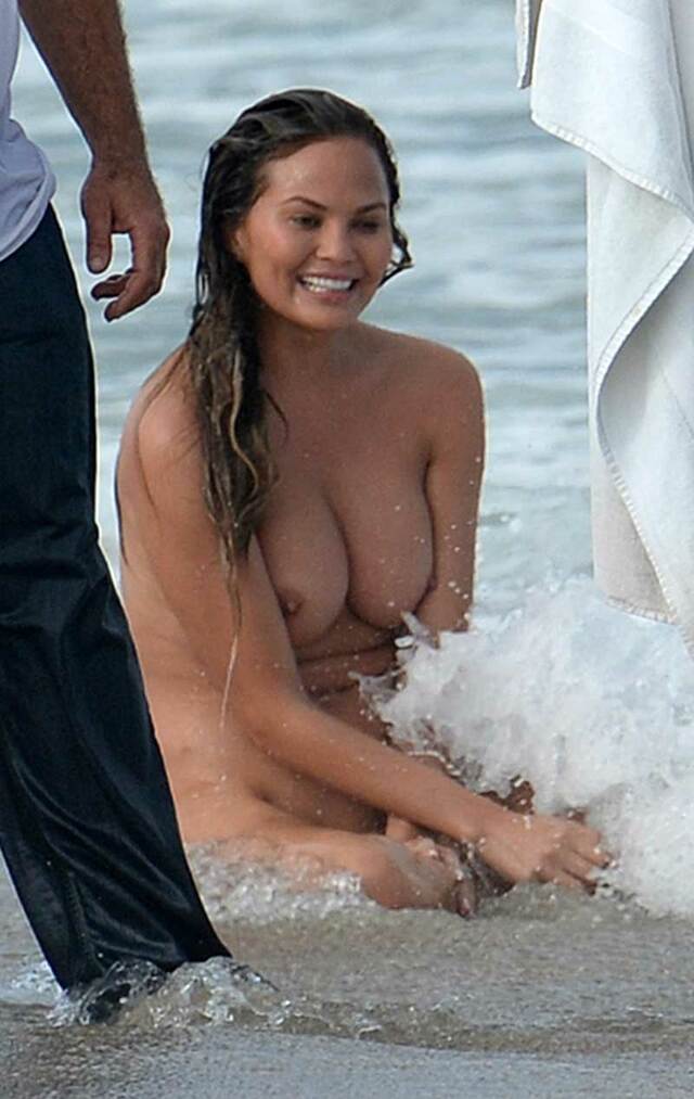 One Very Naked Chrissy Teigen in the Ocean Surf free nude pictures